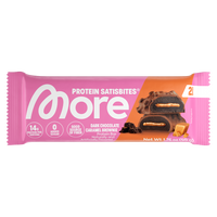 A packaged protein satiskbite bar in a pink wrapper with an orange diagonal section, showing the More brand logo and a photo of a dark chocolate caramel brownie piece on the front.