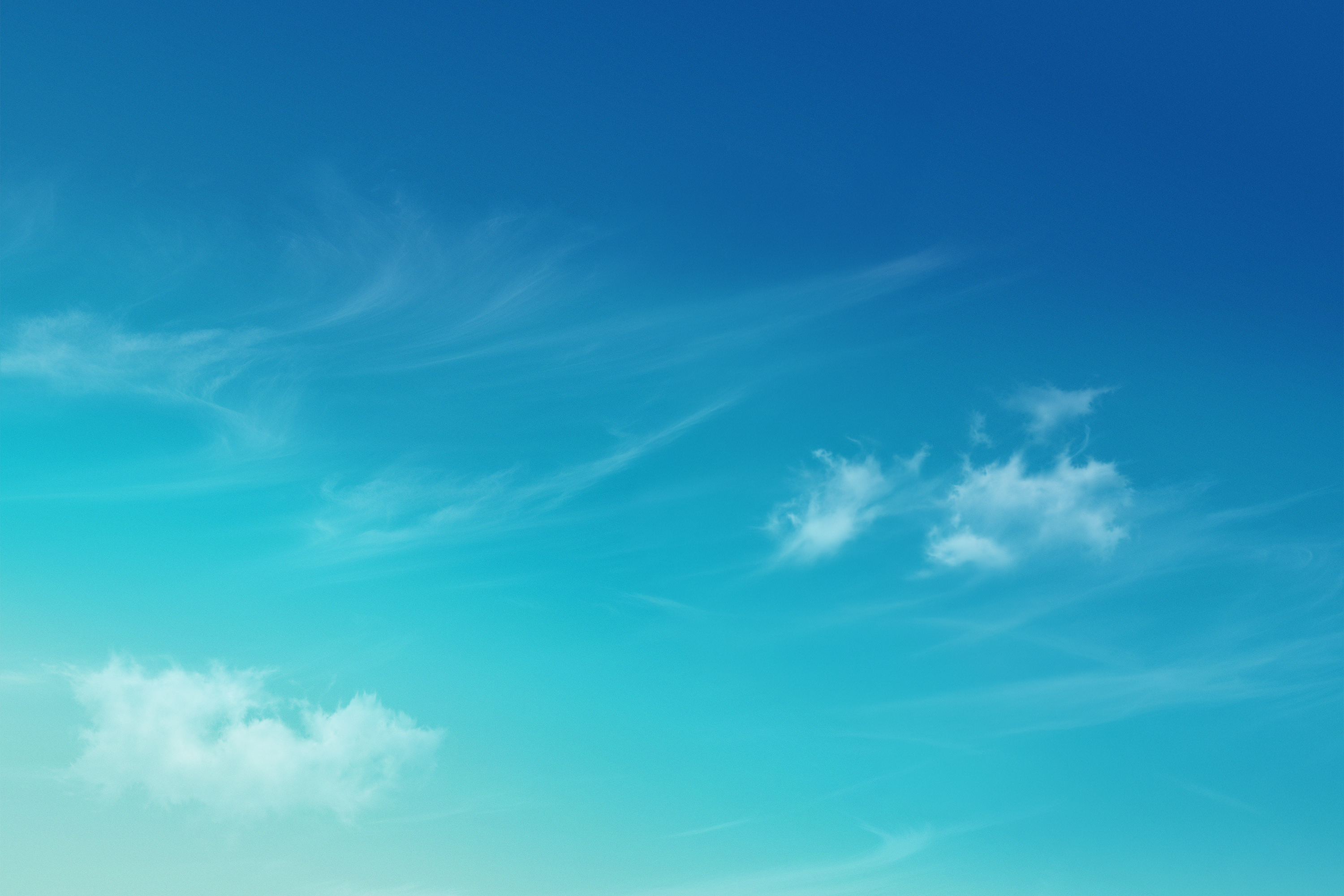 Clear blue sky with a few white clouds